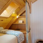 Plafond en bois au-dessus du lit mansardé