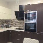 Interesting beige corner kitchen with wenge furniture