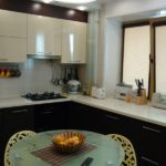 Corner bicolor kitchen furniture with cabinets under the window