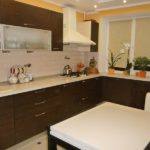 Wenge corner kitchen with white worktops and appliances