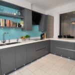 Turquoise wall in the kitchen with gray furniture