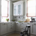 White roman curtains on kitchen windows