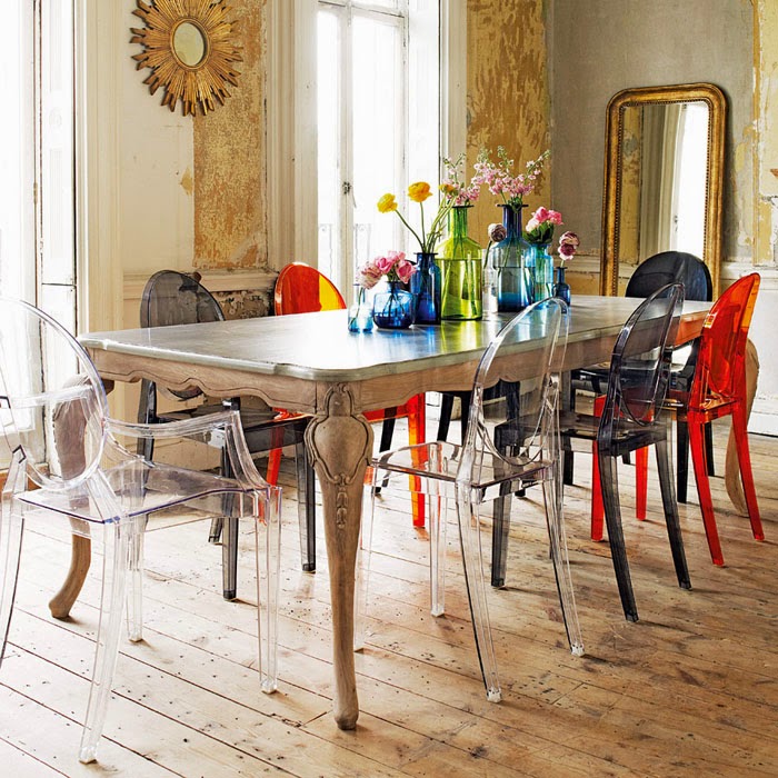 Multicolored plastic chairs with armrests in the kitchen of a private house