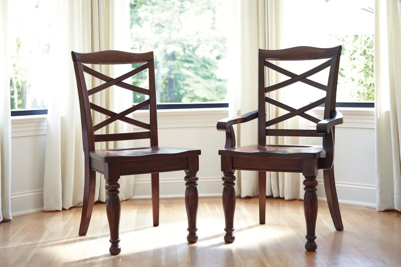 Two wooden kitchen chairs from the same collection