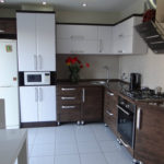Inclined hood on the wall of a modern kitchen