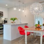 Red chairs in a white kitchen