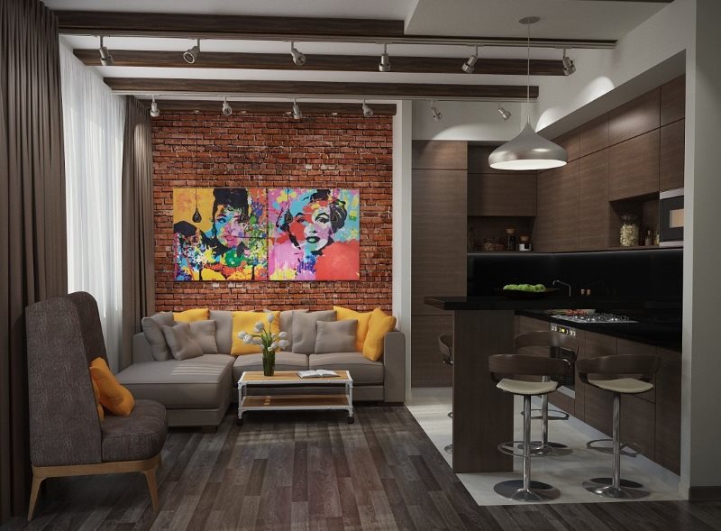 Γκρίζο καναπέ κοντά στον τοίχο από τούβλα της κουζίνας-σαλόνι