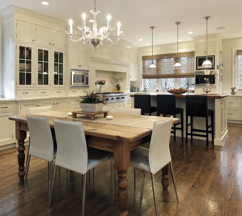 Kronleuchter mit Kerzen über einem hölzernen Esstisch