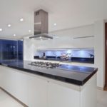 Stainless steel hood on the ceiling of the kitchen