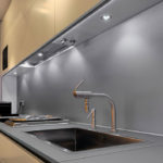 Recessed luminaires at the bottom of the hanging cabinets