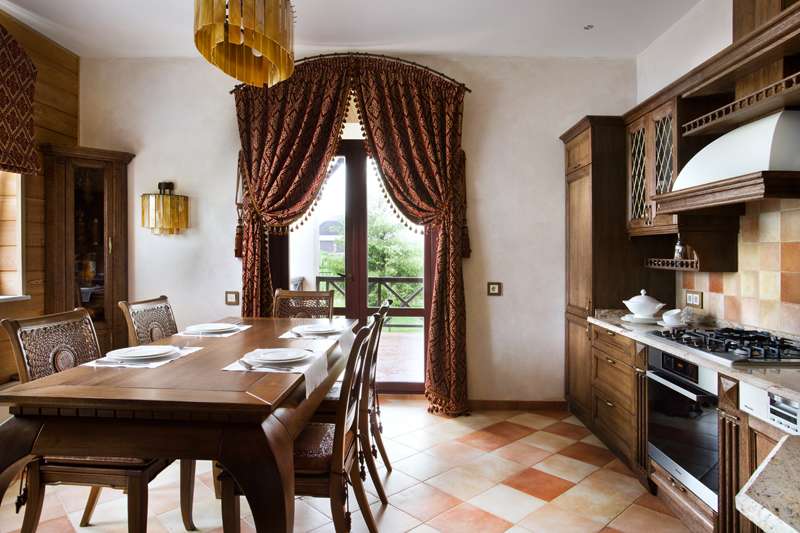 Dense curtains on the door of the kitchen in the style of a chalet