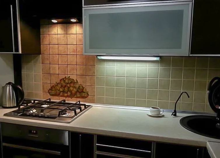 Cooktop illumination with built-in hoods