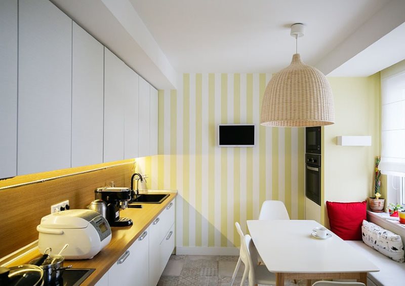 Striped wallpaper on the wall of an elongated kitchen