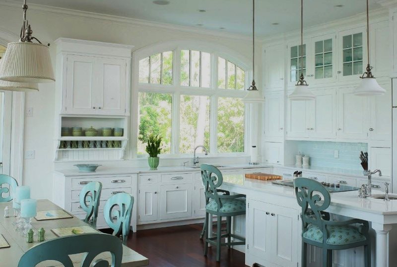 Wooden chairs with armrests in a provence style kitchen