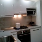 Built-in hood with backlight in a small kitchen