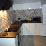 Two-chamber refrigerator in the kitchen with an L-shaped set