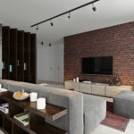 Gray furniture in a room with a brick wall