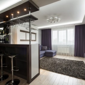 Dark gray carpet on wooden floor.