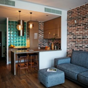 Blue sofa near a brick wall