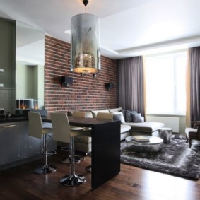 Wallpaper under a brick in the kitchen-living room