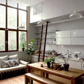 Ladder in the kitchen with a large window.