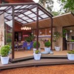 Φυτά σε γλάστρες στο ξύλινο πάτωμα μιας καλοκαιρινής κουζίνας