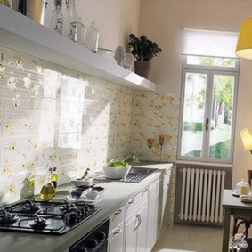 Papel de parede com estampa floral sob o vidro do avental da cozinha