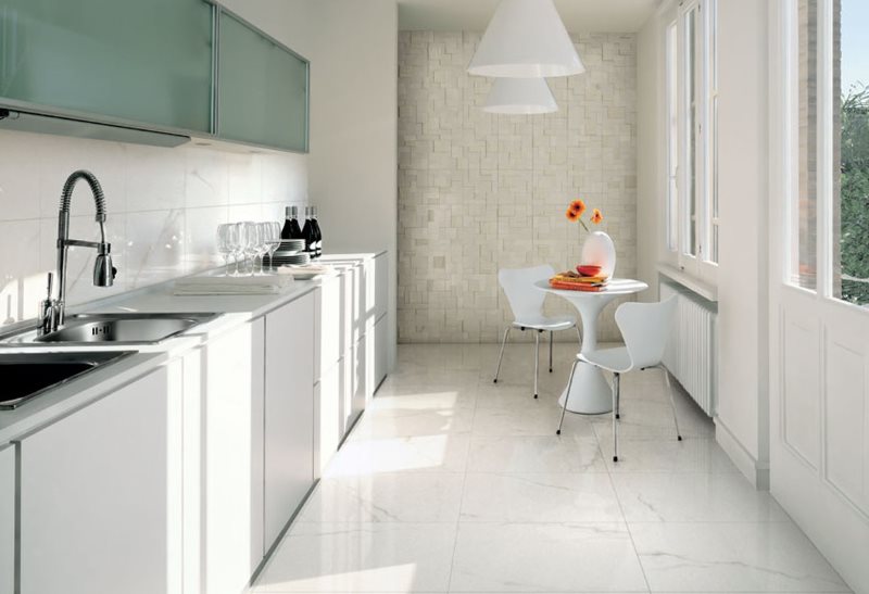 Narrow kitchen with white tiles on the floor