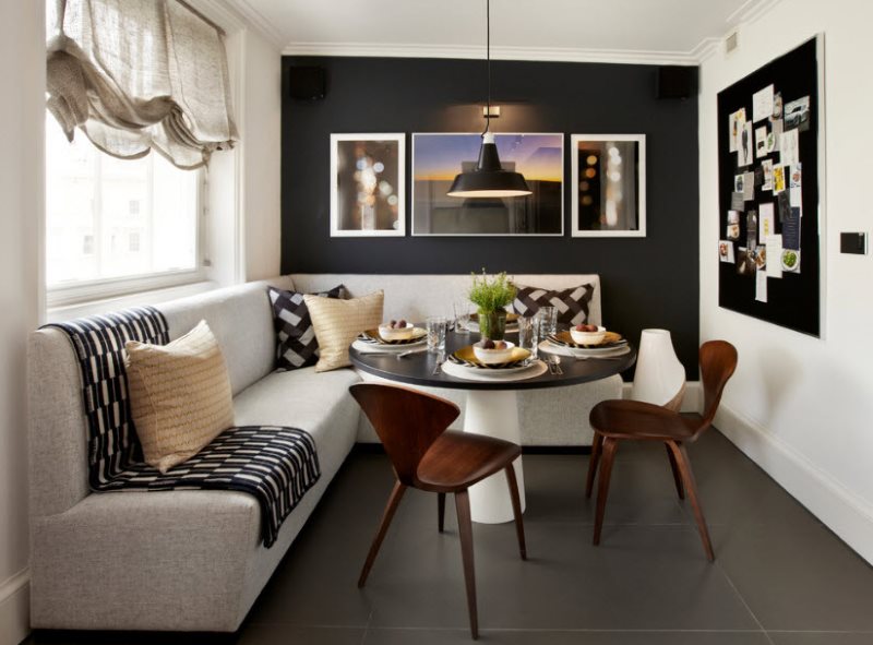 Corner sofa with light upholstery on a dark floor