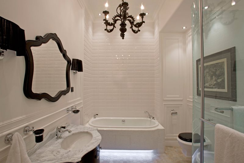 Black rimmed mirror on a white bathroom wall