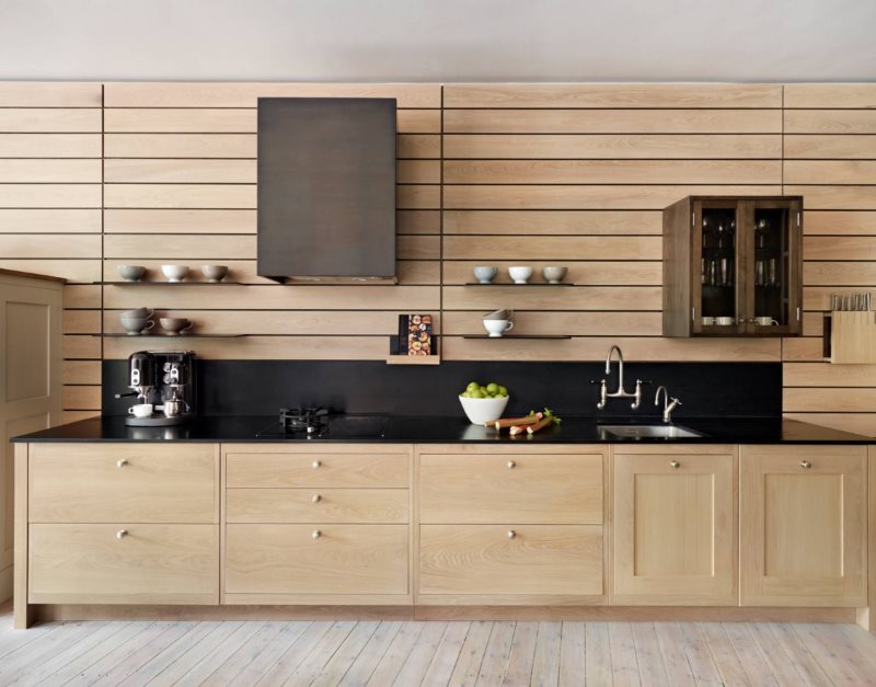 Hanging cabinets and shelves on the wall of the kitchen with wooden panels