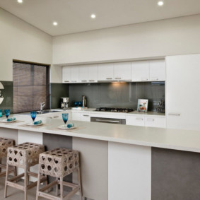 Gray apron in the kitchen with white furniture