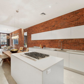 White hanging cabinets on a brick wall