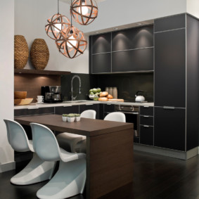 Modern plastic chairs in the kitchen with dark furniture