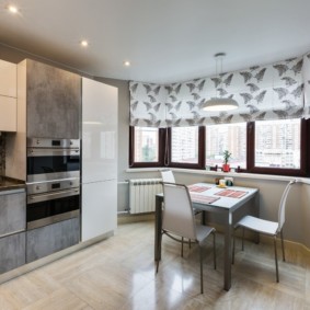 Roman curtains on the windows in a bay window