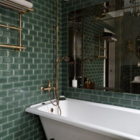Large mirror above the cast-iron bathtub