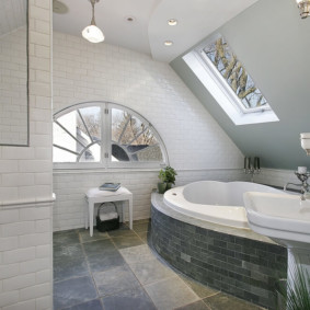 Arched window in the attic of a private house