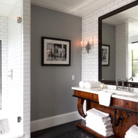 A stack of white towels on a wooden shelf