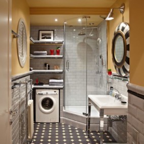 The interior of a narrow bathroom with a washing machine