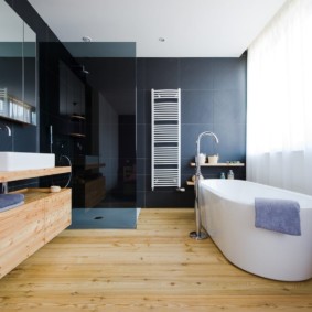 White acrylic bathtub on plank floor