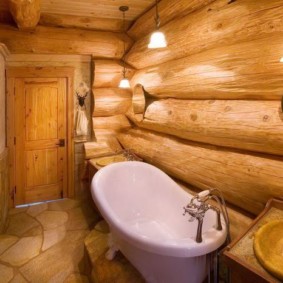 Acrylic bathtub along a log wall