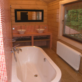 A long heating battery under the window of a private house