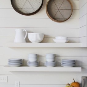 White dishes on open shelves
