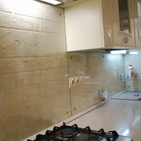 Textured wallpaper under the glass of the kitchen apron