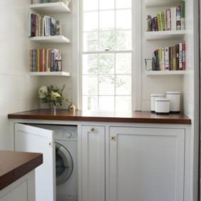Book shelves on the kitchen wall