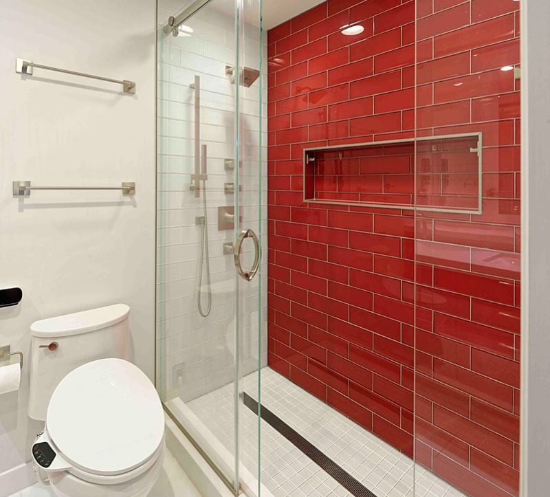 Red ceramic tiles on the wall of the shower stall