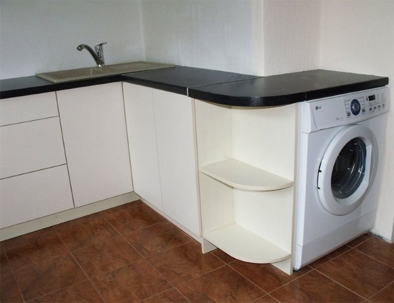 White washing machine under the black countertop