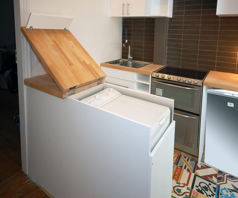 Folding wooden worktop above a washing machine