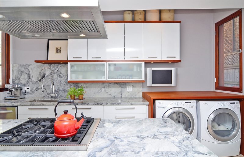 Two washing machines in one cupboard