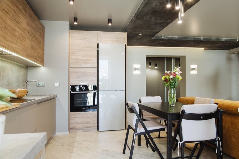 Zoning of the kitchen-living room with a bunk ceiling